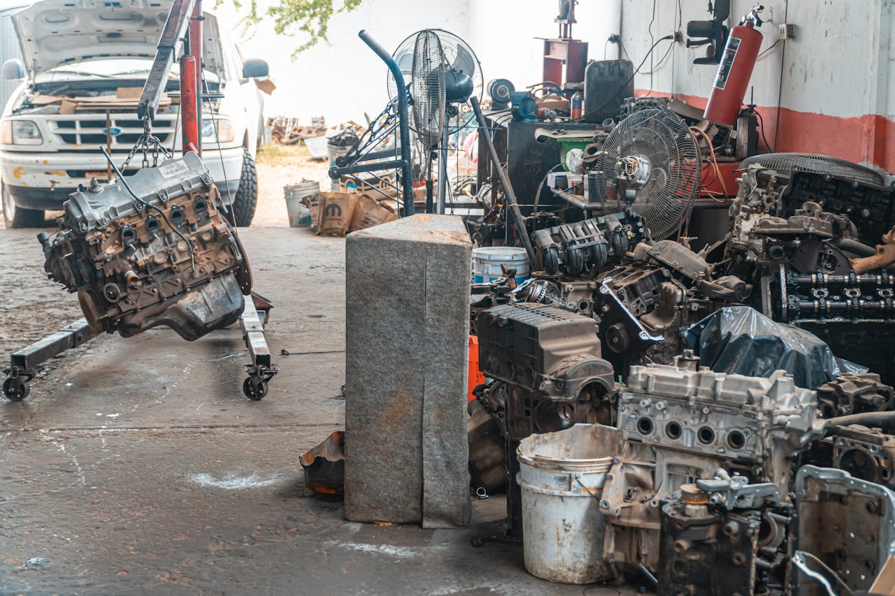 Auto workshop displaying a collection of engine parts and repair equipment.
