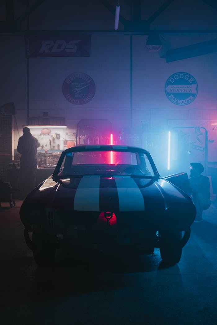 menu-07 A classic car in a neon-lit garage, exuding a cool automotive vibe.